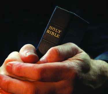 holding the Bible