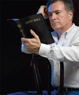 man holding Bible