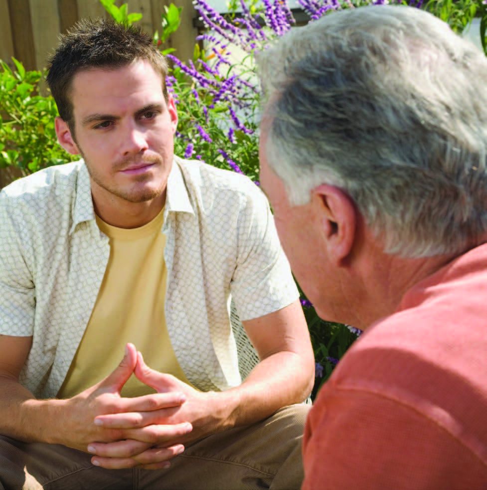 young man talking to older man