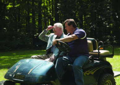 Dr. Meredith riding a 4-wheeler with Sheldon Monson