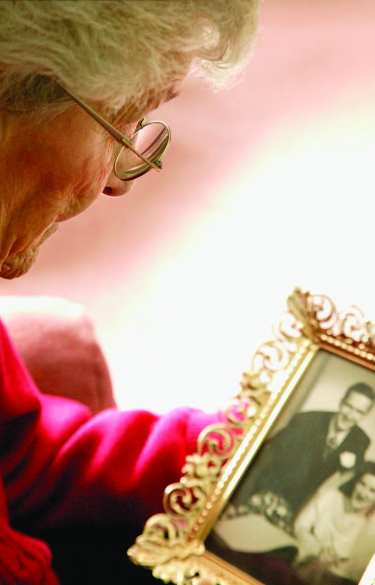 widow looking at photo of husband