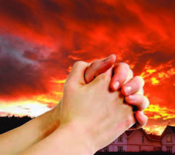 prayer hands in front of ominous sky